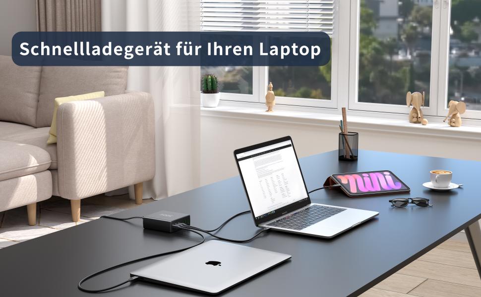 Laptop charging setup on desk with additional devices, coffee cup, and window view. Text mentions fast charging for laptops.